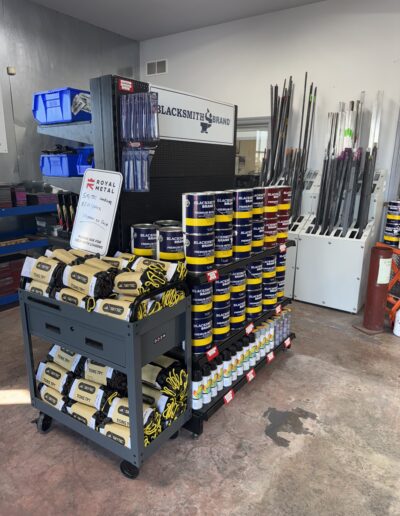metal paint and gloves on shelf, flat bar in indoor bin