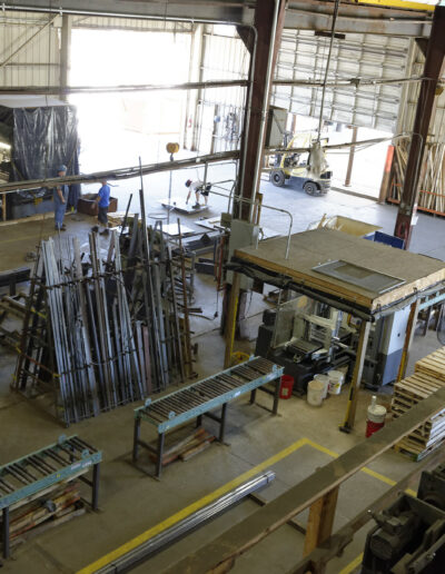 inside of commercial warehouse. there is machinery and stacks of steel