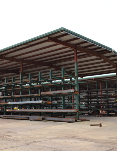 side view of homebuilding pavilion with steel beams and beams cutting area under it