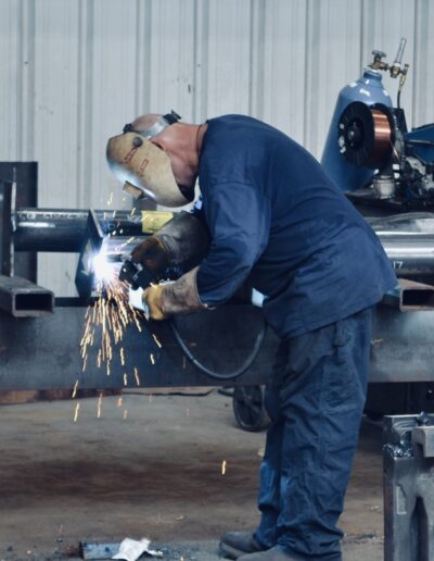welder welding an adjustable column