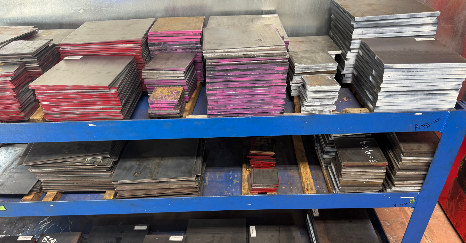 pieces of cut plate on a blue shelf in the retail store